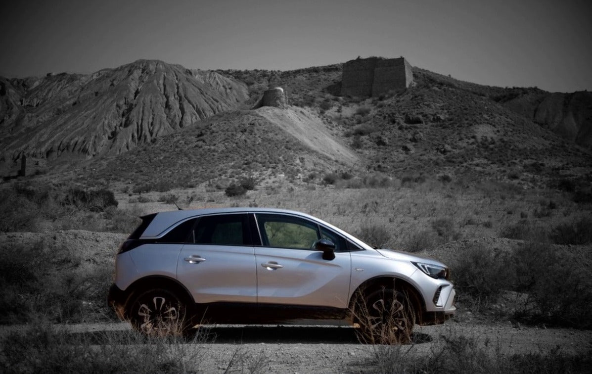A Fujifilm RAW photo of a car in the desert, then the same photo in Sablefilm Layers with a Black and White layer and an AI subject mask that spares the car, after