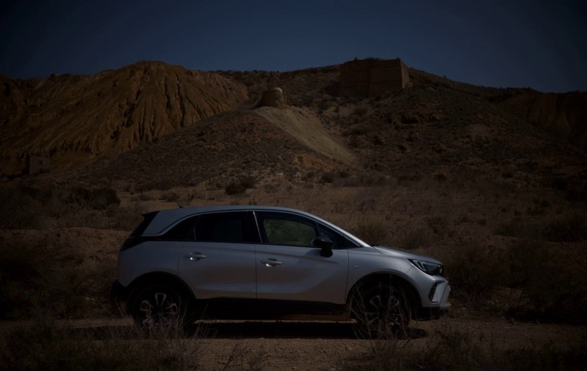 A Fujifilm RAW photo of a car in the desert, then the same photo in Sablefilm Layers with a Black and White layer and an AI subject mask that spares the car, before
